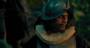 Movie still from “Tom Thumb” (2001), directed by Olivier Dahan – A person wearing a hat; Close Up shot, Over the shoulder angle