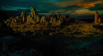 Movie still from “Tom Thumb” (2001), directed by Olivier Dahan – A large rock formation in the middle of the night; Extreme Wide shot, High angle