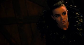 Movie still from “Tom Thumb” (2001), directed by Olivier Dahan – A person wearing a black dress; Close Up shot, Over the shoulder angle