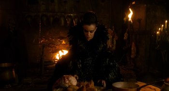 Movie still from “Tom Thumb” (2001), directed by Olivier Dahan – A woman sitting in front of a fire place; Medium shot, High angle