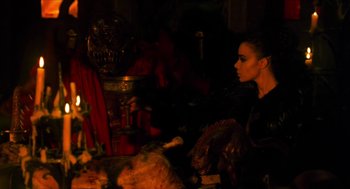 Movie still from “Tom Thumb” (2001), directed by Olivier Dahan – A woman sitting on a chair in a dark room; Medium shot, High angle