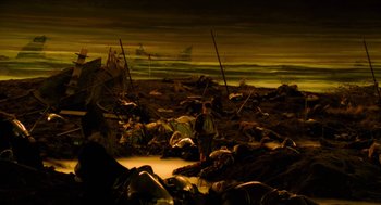 Movie still from “Tom Thumb” (2001), directed by Olivier Dahan – A man standing in the middle of a field; Extreme Wide shot, High angle