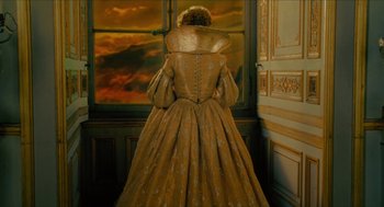 Movie still from “Tom Thumb” (2001), directed by Olivier Dahan – A woman in a long dress standing in front of a window; Medium shot, Low angle