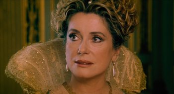 Movie still from “Tom Thumb” (2001), directed by Olivier Dahan – A person wearing a dress; Close Up shot, Over the shoulder angle