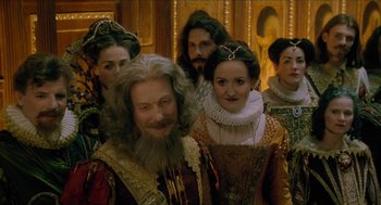 Movie still from “Tom Thumb” (2001), directed by Olivier Dahan – A group of people dressed in renaissance costumes; Medium shot, Over the shoulder angle
