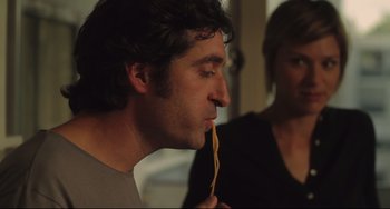 Movie still from “Tomboy” (2011), directed by Céline Sciamma – A person holding a pasta in his mouth; Close Up shot, Over the shoulder angle
