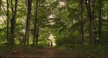 Movie still from “Tomboy” (2011), directed by Céline Sciamma – Two people walking on a path in the woods; Extreme Wide shot, Low angle