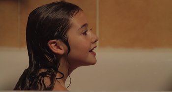 Movie still from “Tomboy” (2011), directed by Céline Sciamma – A young girl is looking to the side; Close Up shot, Over the shoulder angle