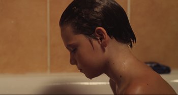Movie still from “Tomboy” (2011), directed by Céline Sciamma – A young woman taking a bath in a tub; Close Up shot, Low angle