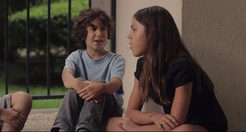 Movie still from “Tomboy” (2011), directed by Céline Sciamma – A boy and a girl sitting next to each other; Medium shot, Over the shoulder angle