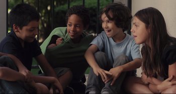 Movie still from “Tomboy” (2011), directed by Céline Sciamma – A group of children sitting on the ground together; Medium shot, High angle