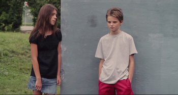 Movie still from “Tomboy” (2011), directed by Céline Sciamma – A boy and a girl standing next to each other; Medium shot, Low angle