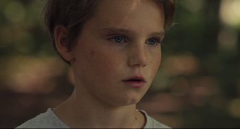 Movie still from “Tomboy” (2011), directed by Céline Sciamma – A young person with blue eyes; Close Up shot, Low angle