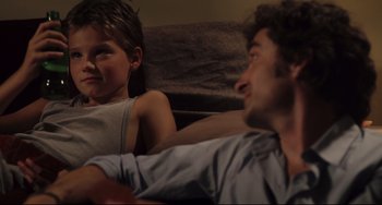 Movie still from “Tomboy” (2011), directed by Céline Sciamma – A man and a boy sitting on a couch together; Close Up shot, Over the shoulder angle