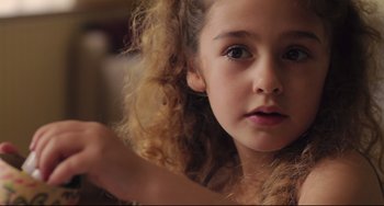 Movie still from “Tomboy” (2011), directed by Céline Sciamma – A young girl with curly brown hair; Close Up shot, Over the shoulder angle