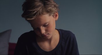 Movie still from “Tomboy” (2011), directed by Céline Sciamma – A young boy is looking down at his face; Close Up shot, High angle