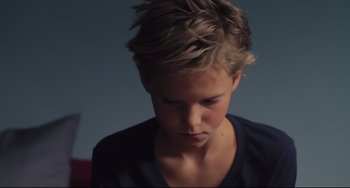 Movie still from “Tomboy” (2011), directed by Céline Sciamma – A young boy is looking down at his face; Close Up shot, High angle