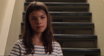 Movie still from “Tomboy” (2011), directed by Céline Sciamma – A young girl in a striped shirt looking at the camera; Close Up shot, Low angle