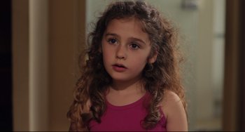Movie still from “Tomboy” (2011), directed by Céline Sciamma – A little girl with curly hair wearing a pink shirt; Close Up shot, High angle