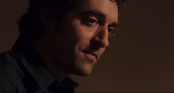 Movie still from “Tomboy” (2011), directed by Céline Sciamma – A man's face in a dark room; Close Up shot, Over the shoulder angle