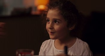Movie still from “Tomboy” (2011), directed by Céline Sciamma – A little girl sitting at a table with a pen in her hand; Close Up shot, Over the shoulder angle