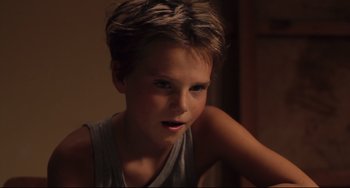 Movie still from “Tomboy” (2011), directed by Céline Sciamma – A young boy is looking into the camera; Close Up shot, High angle