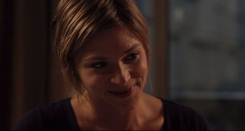 Movie still from “Tomboy” (2011), directed by Céline Sciamma – A woman smiling for the camera; Close Up shot, Over the shoulder angle