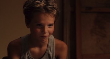 Movie still from “Tomboy” (2011), directed by Céline Sciamma – A young boy is smiling for the camera; Close Up shot, High angle