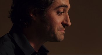 Movie still from “Tomboy” (2011), directed by Céline Sciamma – A man's face in a dark room; Close Up shot, Low angle