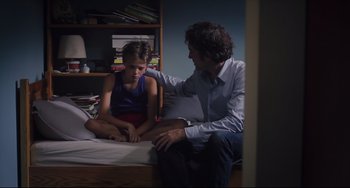 Movie still from “Tomboy” (2011), directed by Céline Sciamma – A man sitting on a bed next to a young girl; Medium shot, Over the shoulder angle