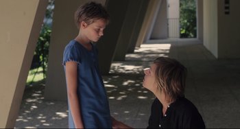 Movie still from “Tomboy” (2011), directed by Céline Sciamma – A woman and a girl are standing next to each other; Medium shot, Over the shoulder angle
