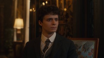 Movie still from “Anne with an E” (2017), created by Moira Walley-Beckett – A man in a suit and tie looking at the camera; Close Up shot, Low angle