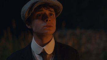 Movie still from “Anne with an E” (2017), created by Moira Walley-Beckett – A young man wearing a suit and a hat; Close Up shot, Low angle