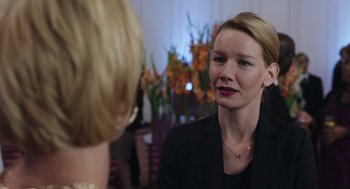 A woman in a black jacket talking to another woman in a black jacket