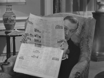 Movie still from “Top Hat” (1935), directed by Mark Sandrich – A man sitting in a chair reading a newspaper; Close Up shot, High angle