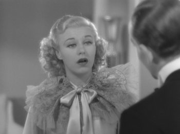Movie still from “Top Hat” (1935), directed by Mark Sandrich – A black - and - white photo of a woman looking at a mirror; Close Up shot, Over the shoulder angle