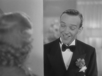 Movie still from “Top Hat” (1935), directed by Mark Sandrich – A black and white photo of a man in a tuxedo; Close Up shot, Over the shoulder angle