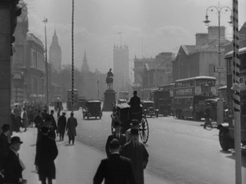 Movie still from “Top Hat” (1935), directed by Mark Sandrich – A black and white photo of a busy street with a horse and carriage; Extreme Wide shot, Low angle