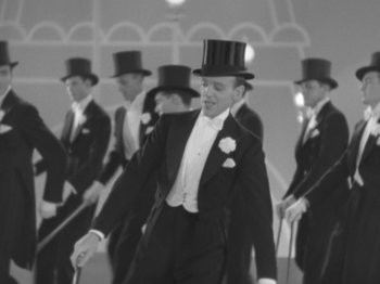 Movie still from “Top Hat” (1935), directed by Mark Sandrich – A group of men in tuxedos and top hats; Medium shot, High angle