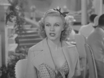 Movie still from “Top Hat” (1935), directed by Mark Sandrich – A black - and - white photo of a woman in a polka dot dress; Close Up shot, Over the shoulder angle