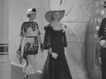 Movie still from “Top Hat” (1935), directed by Mark Sandrich – Two women walking down a staircase in a dress; Medium shot, Low angle