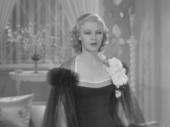 Movie still from “Top Hat” (1935), directed by Mark Sandrich – An old black and white photo of a woman in a dress; Medium shot, Over the shoulder angle