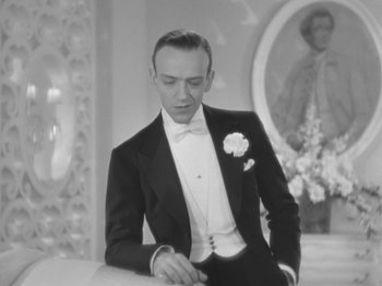 Movie still from “Top Hat” (1935), directed by Mark Sandrich – A black and white photo of a man in a tuxedo; Medium shot, Low angle