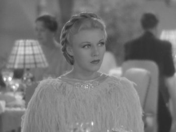 Movie still from “Top Hat” (1935), directed by Mark Sandrich – A black - and - white photo of a woman in a white dress; Close Up shot, Over the shoulder angle