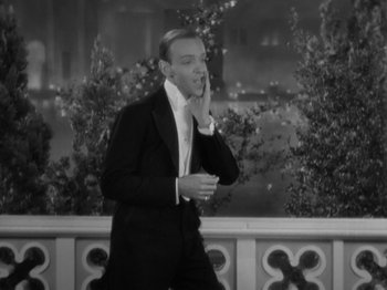 Movie still from “Top Hat” (1935), directed by Mark Sandrich – A black and white photo of a man in a tuxedo; Medium shot, High angle