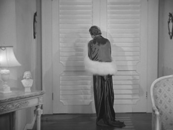 Movie still from “Top Hat” (1935), directed by Mark Sandrich – A woman in a robe and a white feather boa; Wide shot, Over the shoulder angle