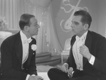 Movie still from “Top Hat” (1935), directed by Mark Sandrich – Two men in tuxedos are talking to each other; Medium shot, High angle