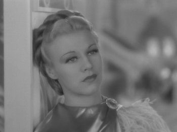 Movie still from “Top Hat” (1935), directed by Mark Sandrich – A black - and - white photo of a woman in a silver dress; Close Up shot, High angle