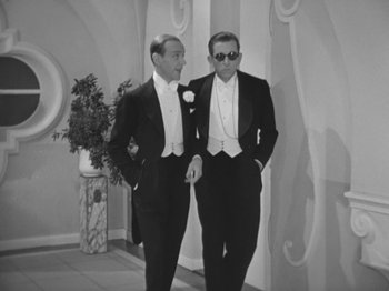 Movie still from “Top Hat” (1935), directed by Mark Sandrich – Two men in tuxedos standing next to each other; Medium shot, High angle