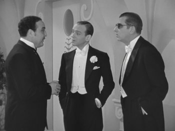 Movie still from “Top Hat” (1935), directed by Mark Sandrich – A black and white photo of men in tuxedos; Medium shot, Over the shoulder angle